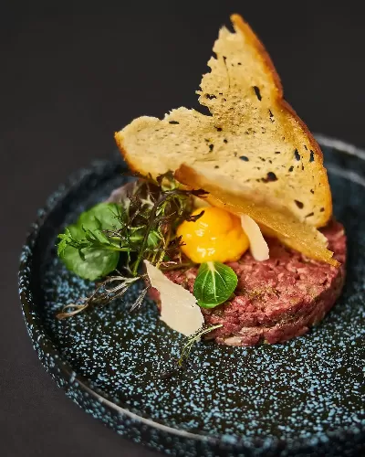  Luxury steak tartare with Parmesan cheese at meat restaurant Amsterdam